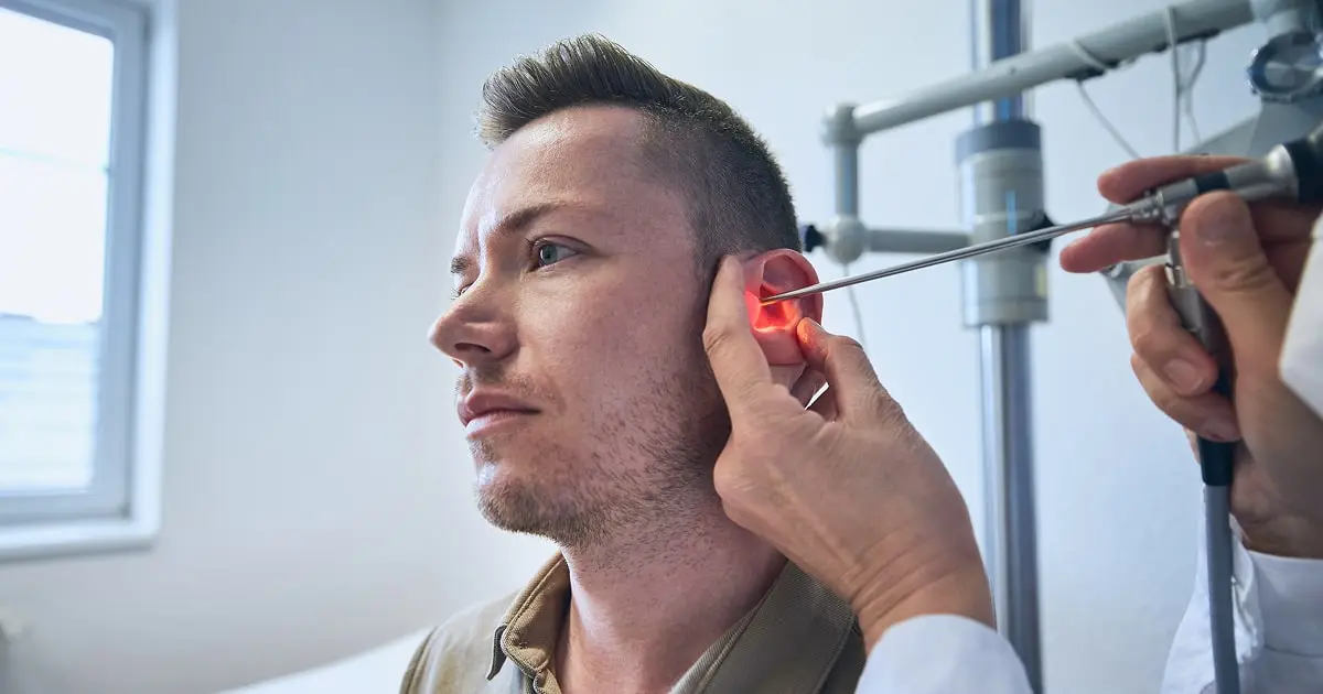 Military veteran undergoing hearing exam due to 3M CAEv2 earplug defects