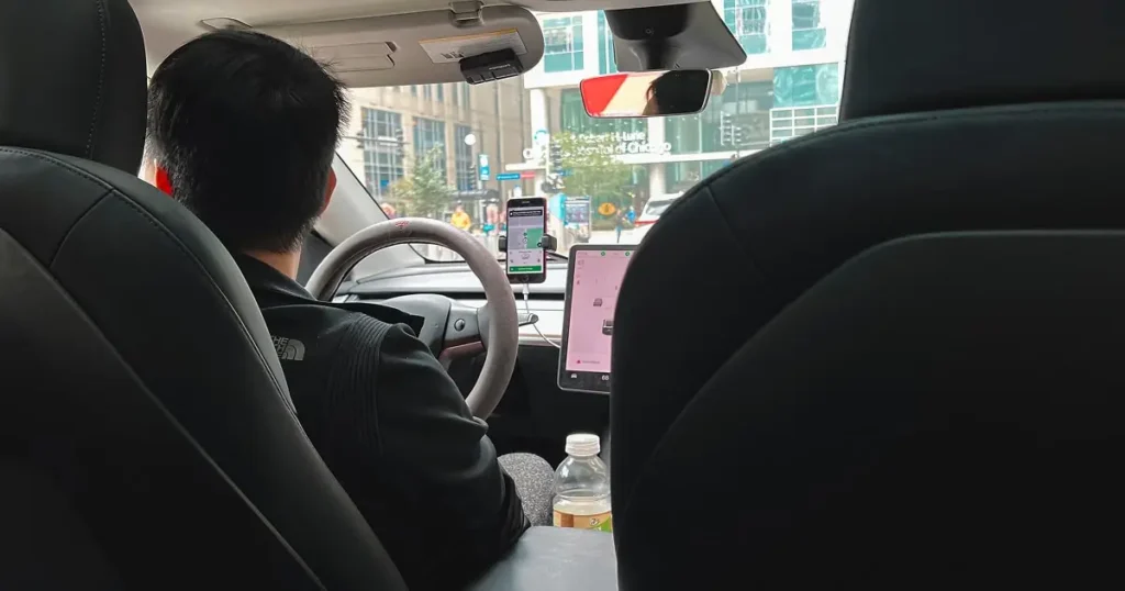 Passenger sitting in Uber rideshare with driver and navigation apps visible
