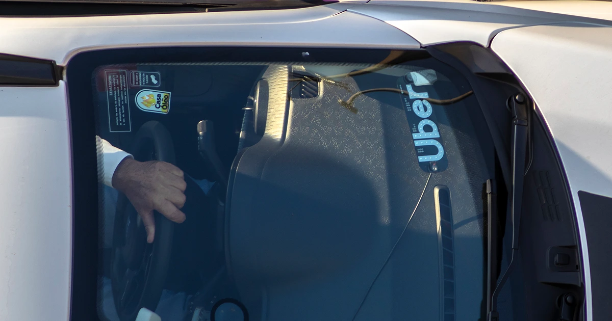 Close-up of a rideshare vehicle with an Uber decal on the windshield, representing ongoing litigation over passenger sexual assault claims.