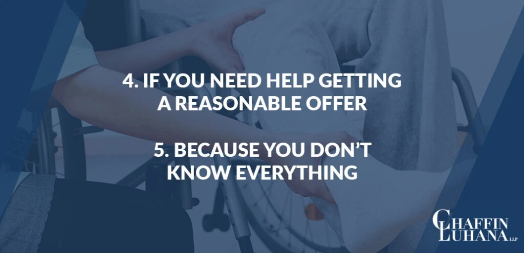 Injured person in a wheelchair meeting with an attorney, showing reasons to hire a personal injury lawyer